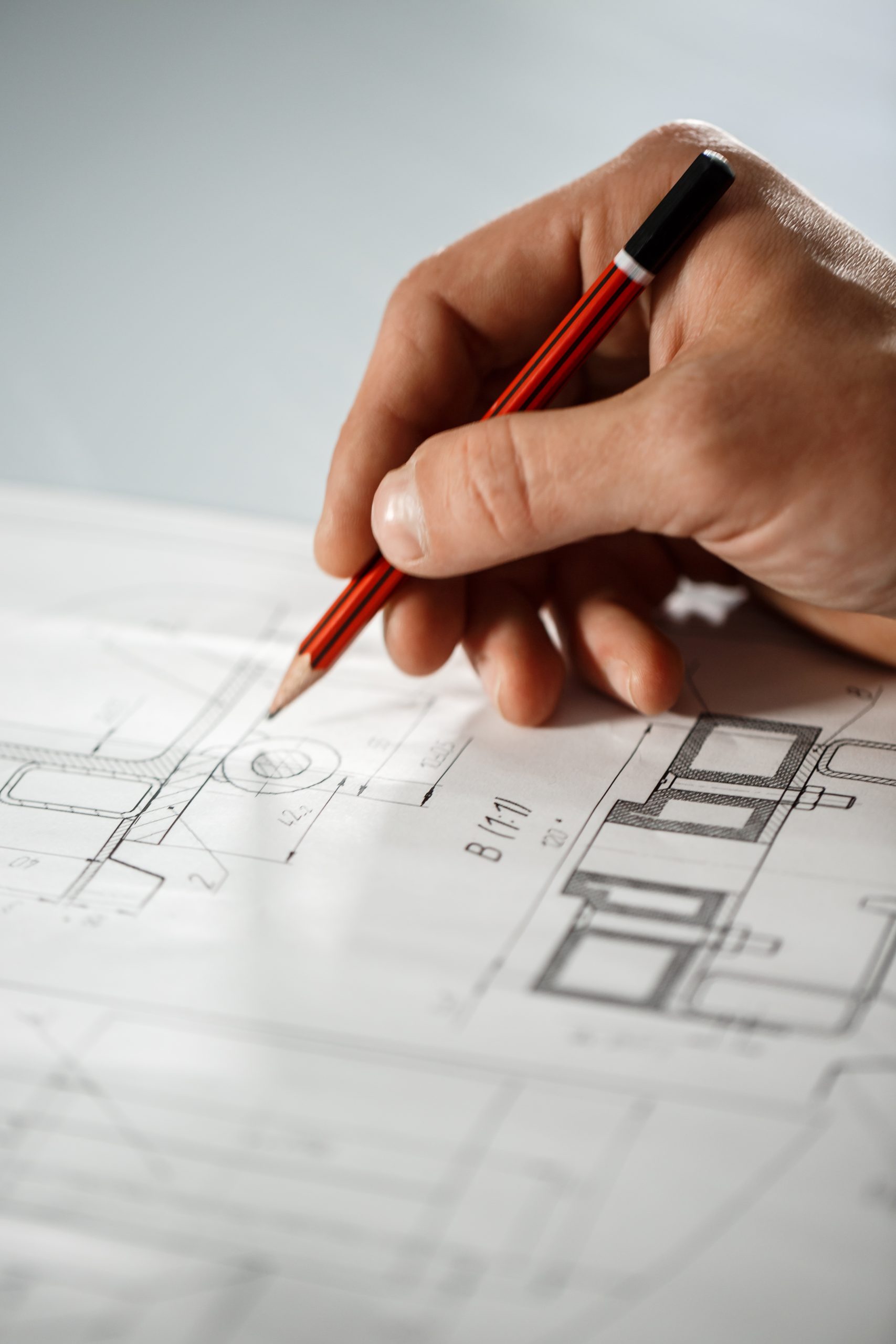 Close up of worker's hand on drawing.